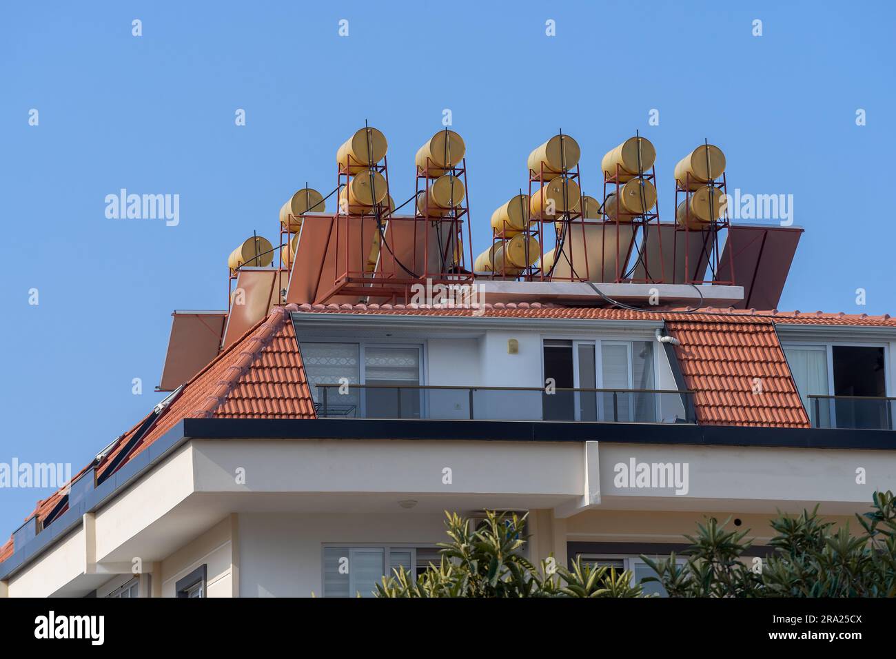 New residential building with solar water heaters on the roof. Urban architecture. Stock Photo