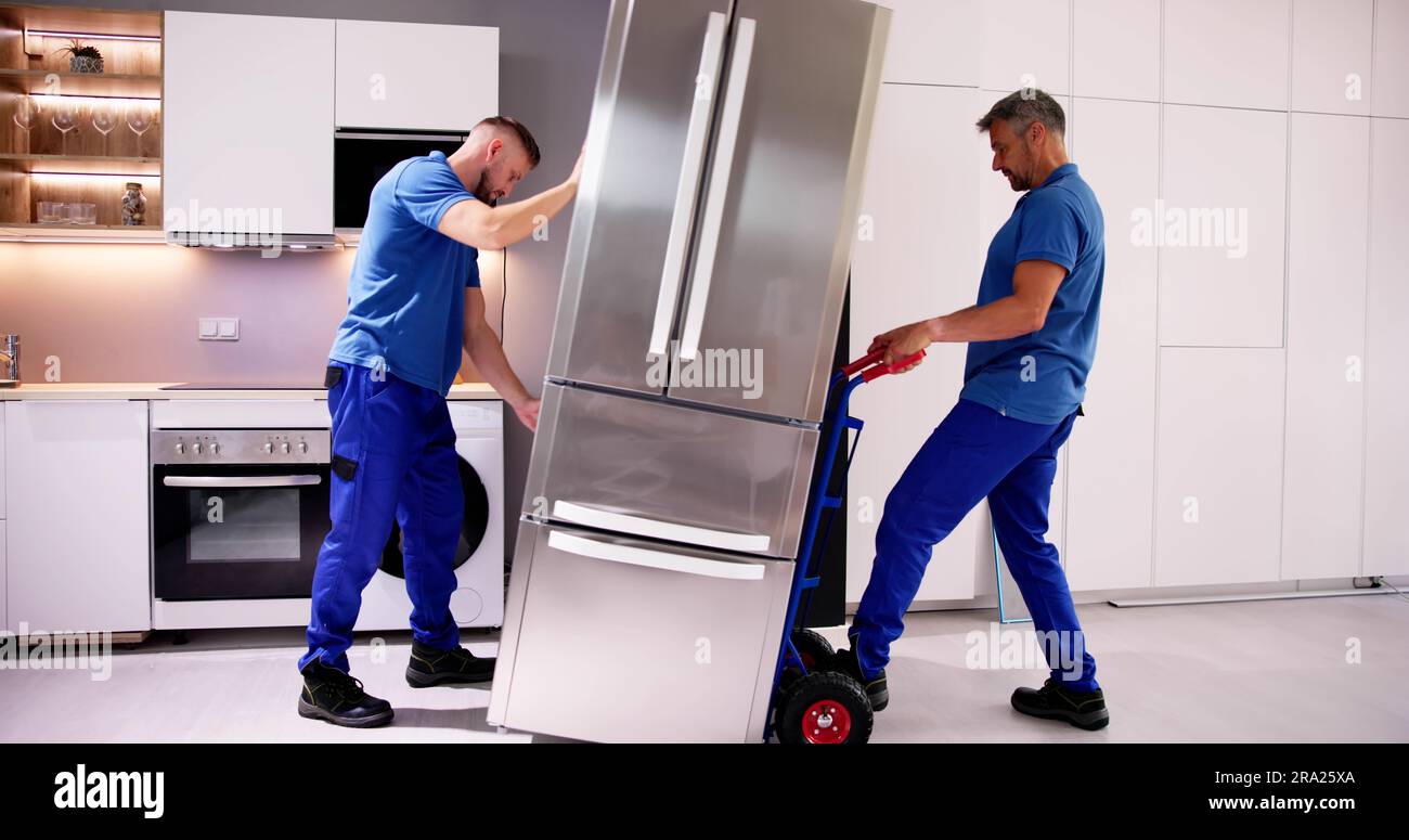 Delivery And Install Of Refrigerator Appliance. Mover Carrying Fridge