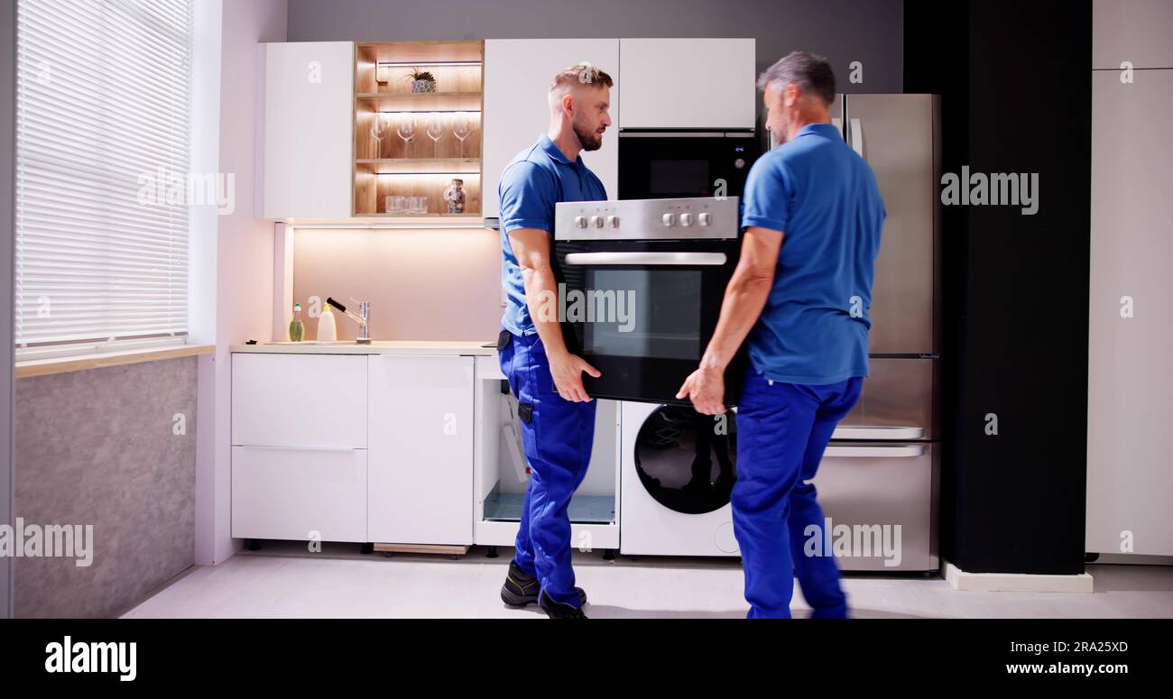 Appliance Delivery And Repair. Movers With Oven Stock Photo Alamy