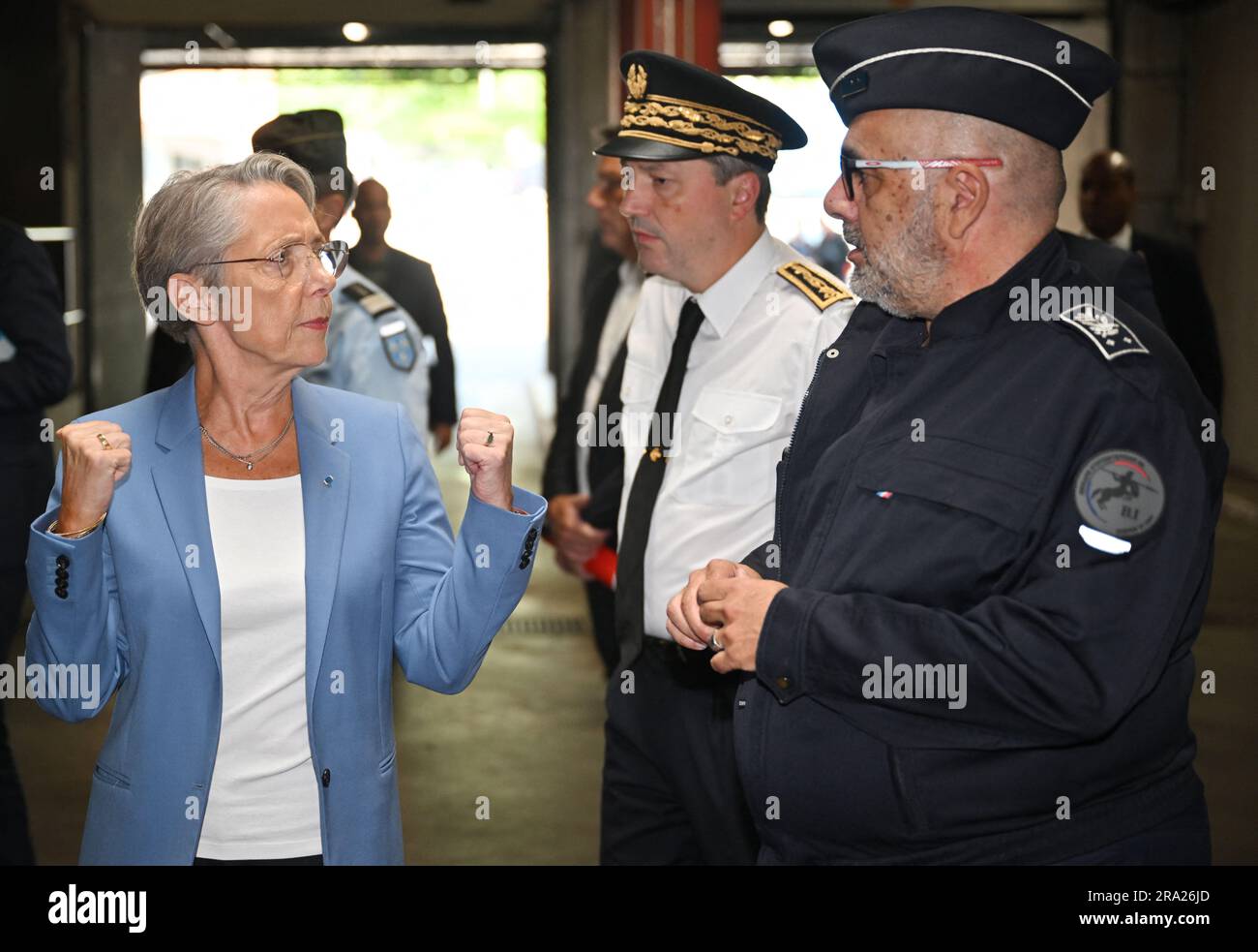 Paris, France, June 30, 2023, French Prime Minister Elisabeth Borne (L) speaks with police officers outside the police station in Evry-Courcouronnes south of Paris on June 30, 2023, following riots three days after a 17-year-old boy was shot in the chest by police at point-blank range in Nanterre, a western suburb of Paris. A third consecutive night of violence in France sparked by the killing of a teenager by a policeman during a traffic stop has left 249 police and gendarmes injured, the interior ministry announced on June 30. Nahel M., 17, was shot in the chest at point-blank range on the m Stock Photo