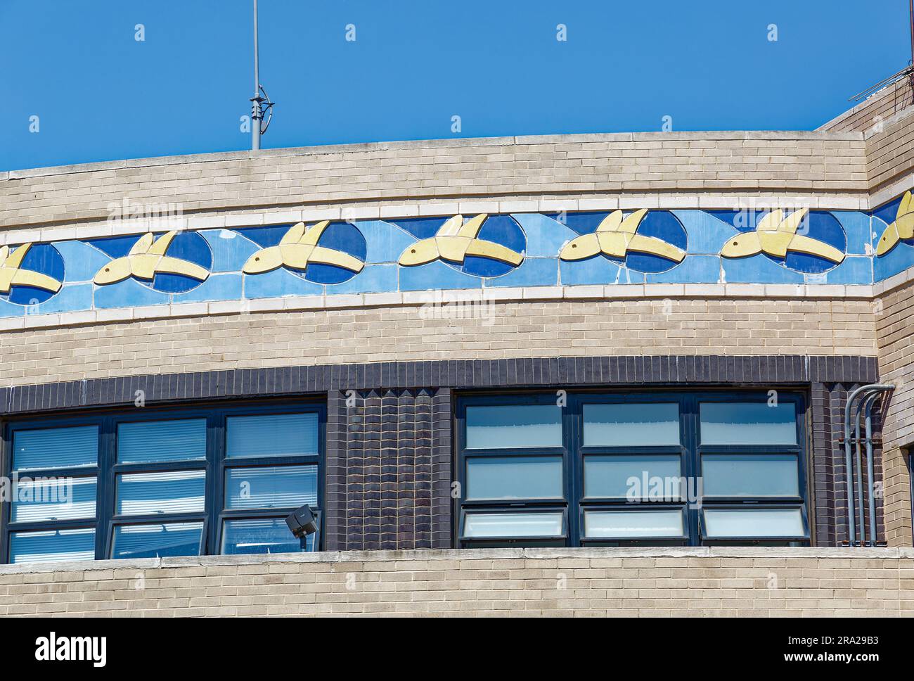 Blue and white flying fish encircle the Art Deco landmark Marine Air Terminal at New York’s LaGuardia Airport. Stock Photo
