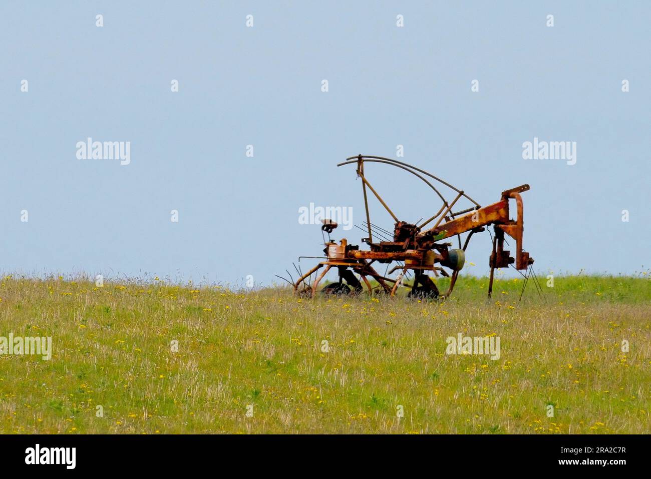 Old and abandoned Farm machinery on the Machair. Machair is a Gaelic word meaning fertile low lying grassy plain. Stock Photo