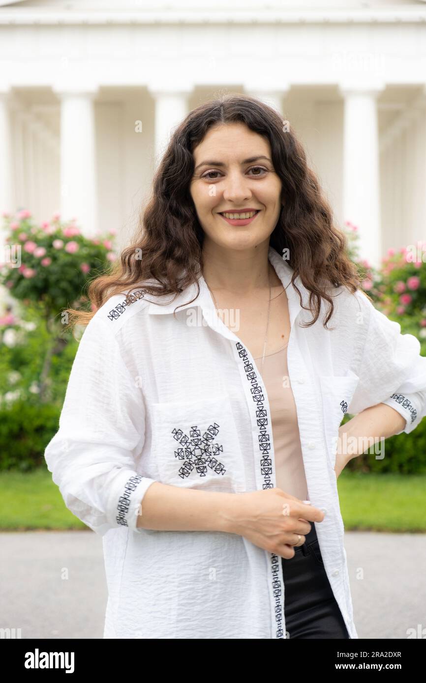 Beautiful successful 35-year-old woman in white shirt walking in the ...