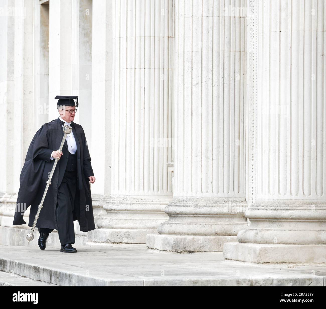 An Esquire Bedell (mace bearer) in academic dress at Senate House
