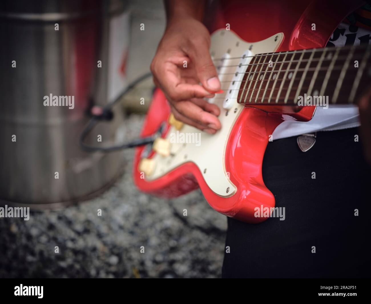 THE man indoors tuning guitar, front view and copy space. Stock Photo