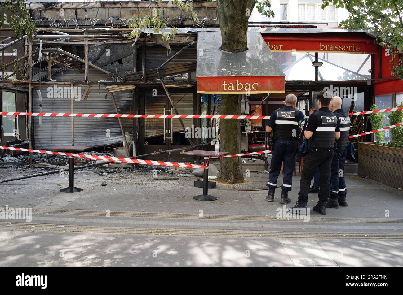 The Marie de Paris and French Police look at a café that has been attacked after a third night of violence and riots over police killing of a teenager, Le Village des Fêtes Café, Rue Louise Thuliez, Place de Fêtes, 75019, Paris, France - 30 June 2023 Stock Photo