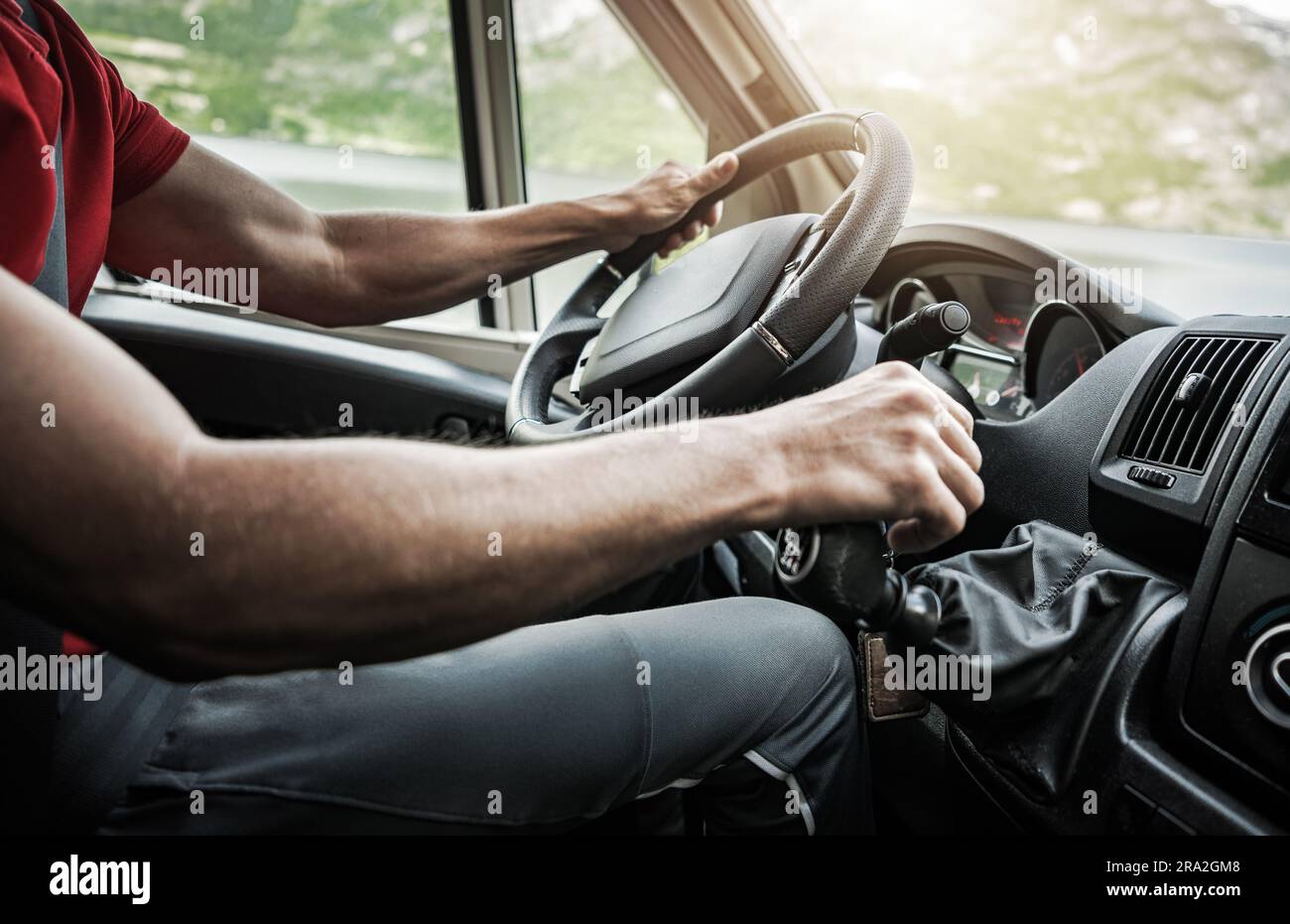 Caucasian Man Driving European Manual Transmission Camper Van Cabin Close Up. Stock Photo