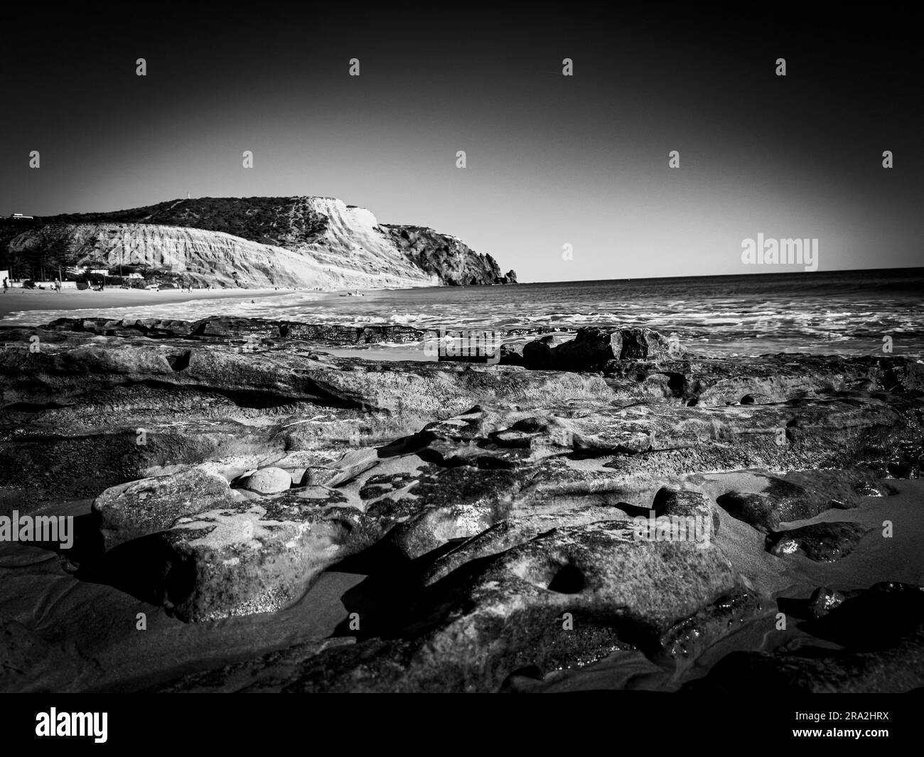 A black and white landscape featuring a rocky shoreline Stock Photo - Alamy