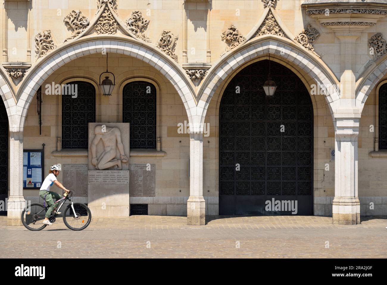 France, Pas de Calais, Arras, Place des Héros, cyclist in front of Town Hall of Arras topped with its 77 meters belfry listed as World Heritage by UNESCO Stock Photo