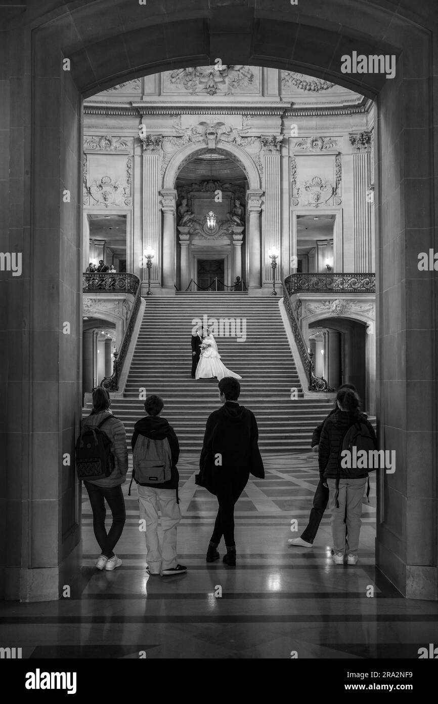 People watching a wedding couple having photographs taken at City Hall, San Francisco, USA Stock Photo