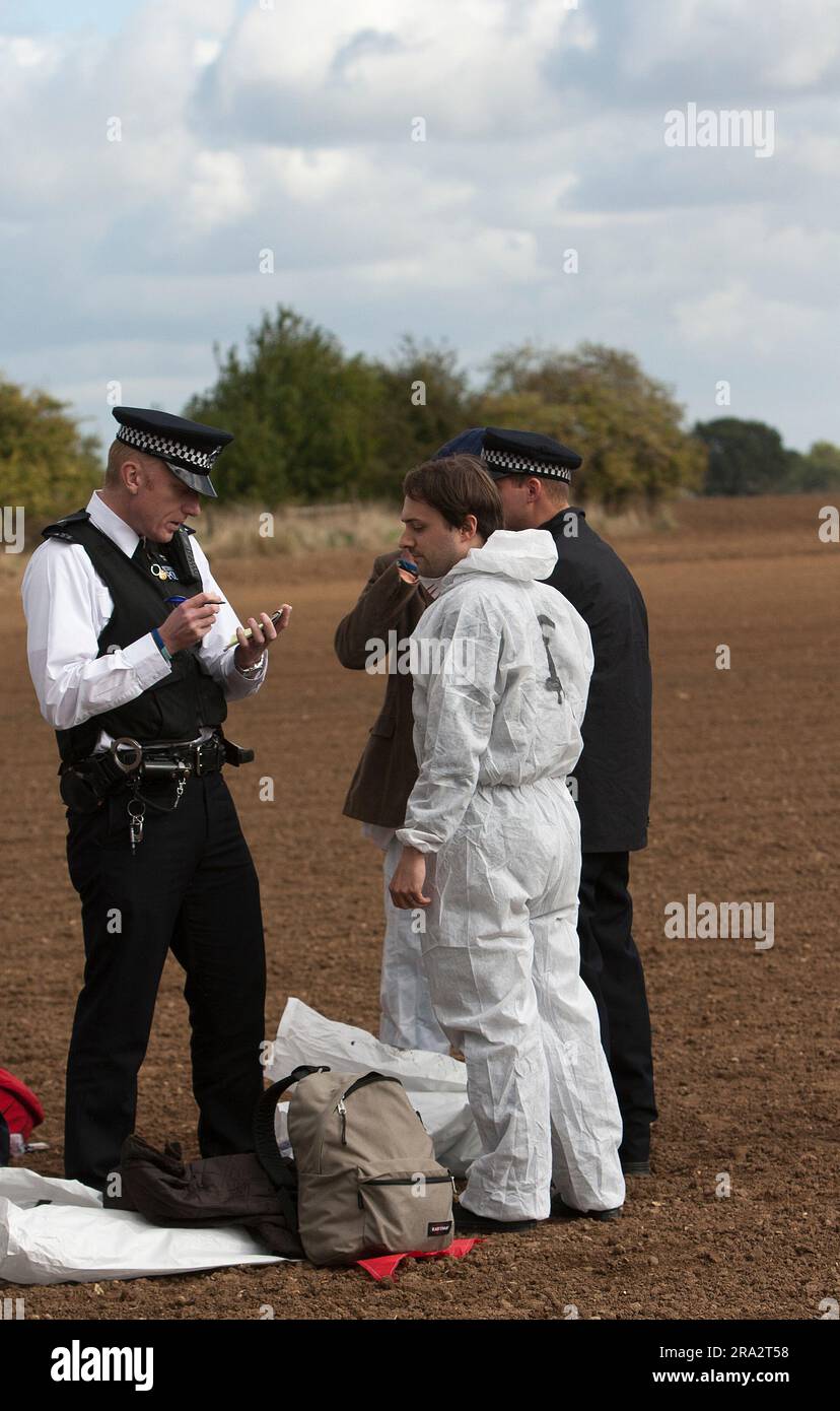demonstrator from Crude Awakening being questioned by police outside Shell Oil refinery in Stanford Essex Stock Photo