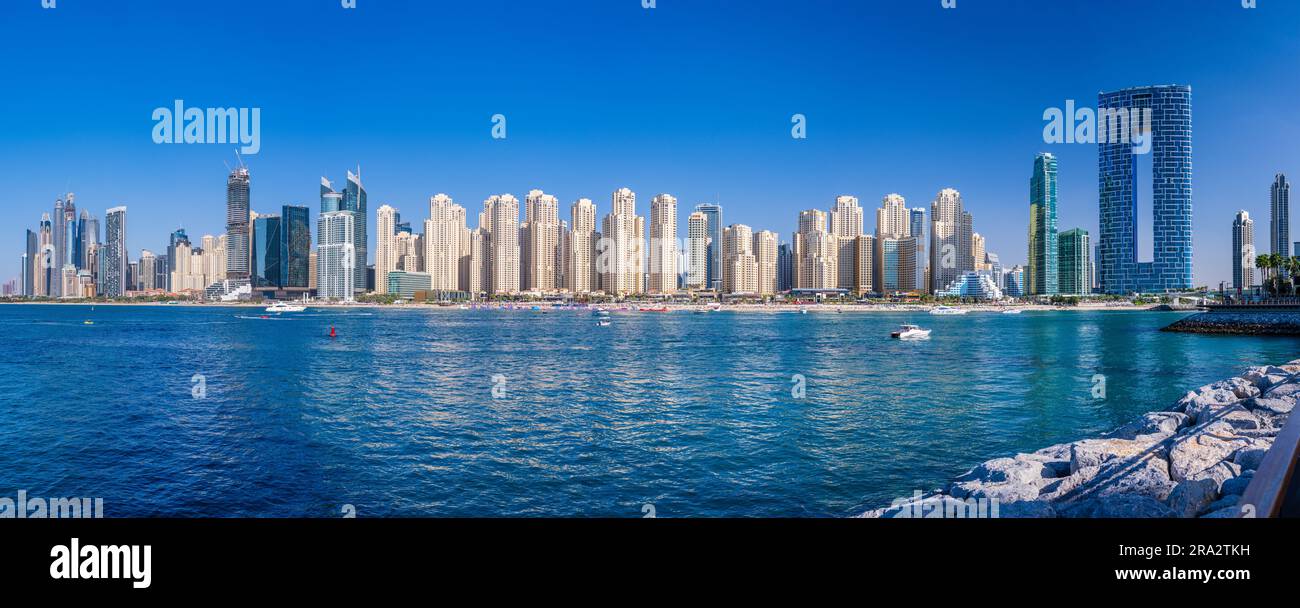 Wide panorama of new apartments among hotels on oceanfront in Jumeirah Beach Residence area of Dubai Stock Photo