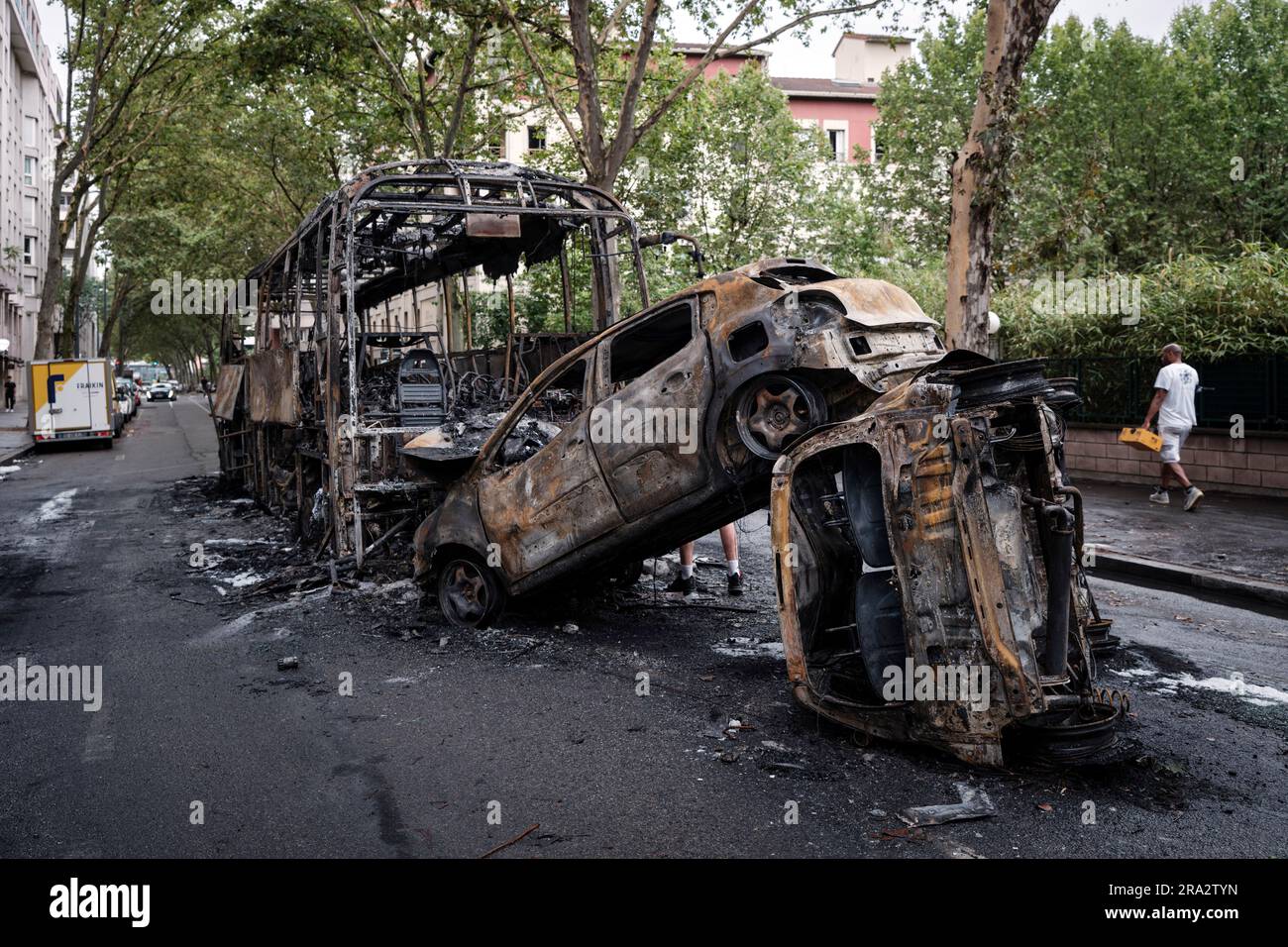 Charred cars and bus are pictured in Lyon, central France, Friday, June