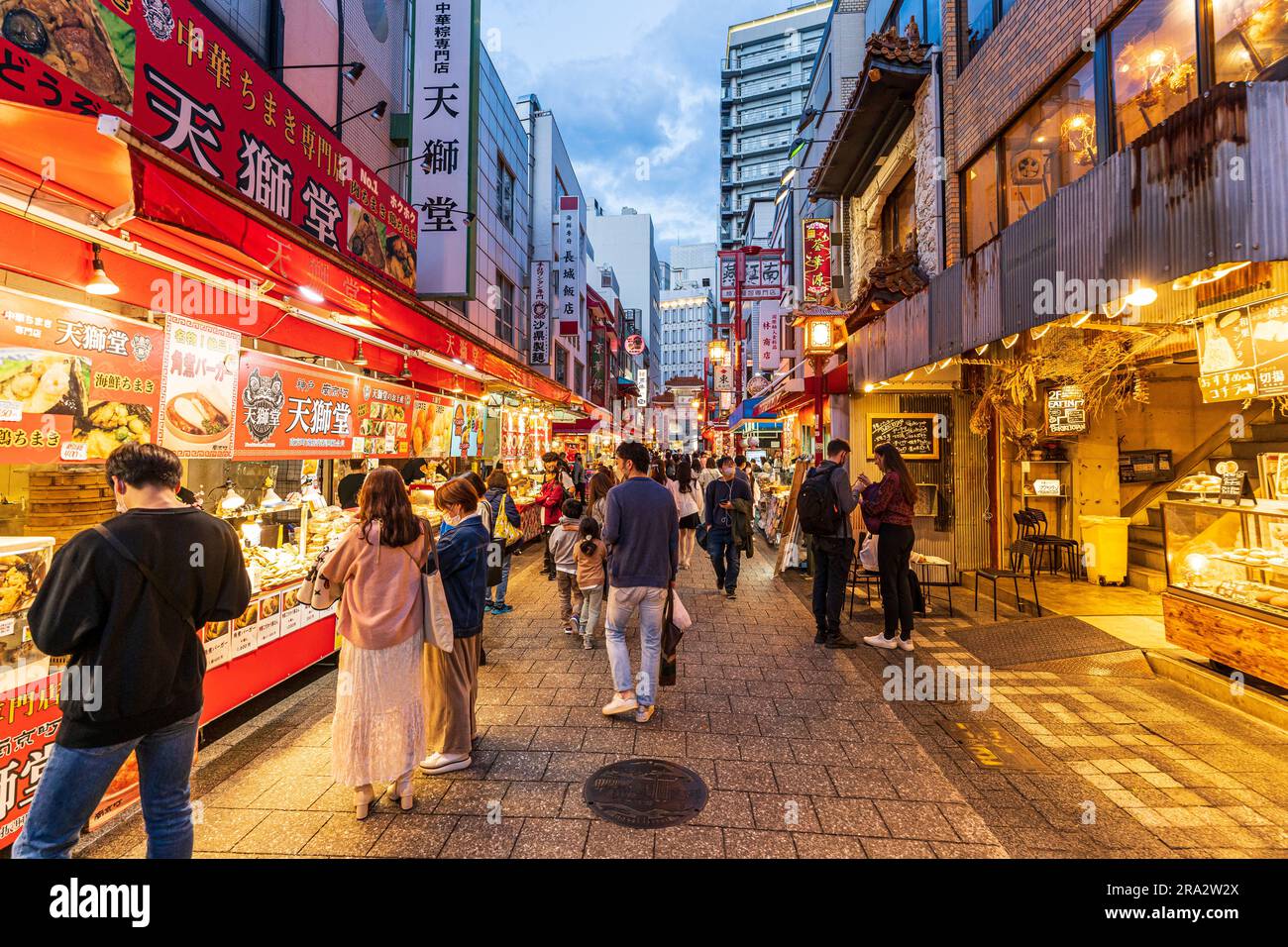 Busy food stalls and restaurants on both sides of the crowded main