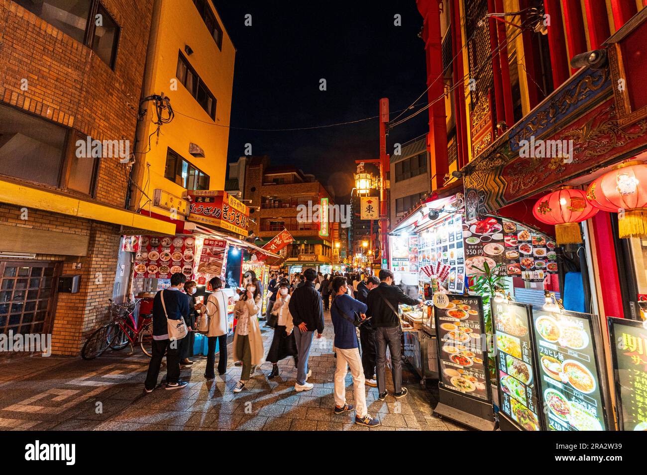 Busy food stalls and restaurants on both sides of the crowded main
