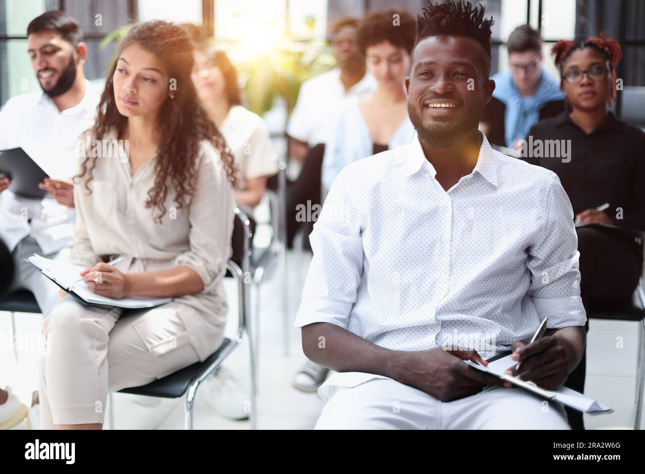 Audience at the conference hall. Business and Entrepreneurship concept. Focus on unrecognizable people in audience. Stock Photo