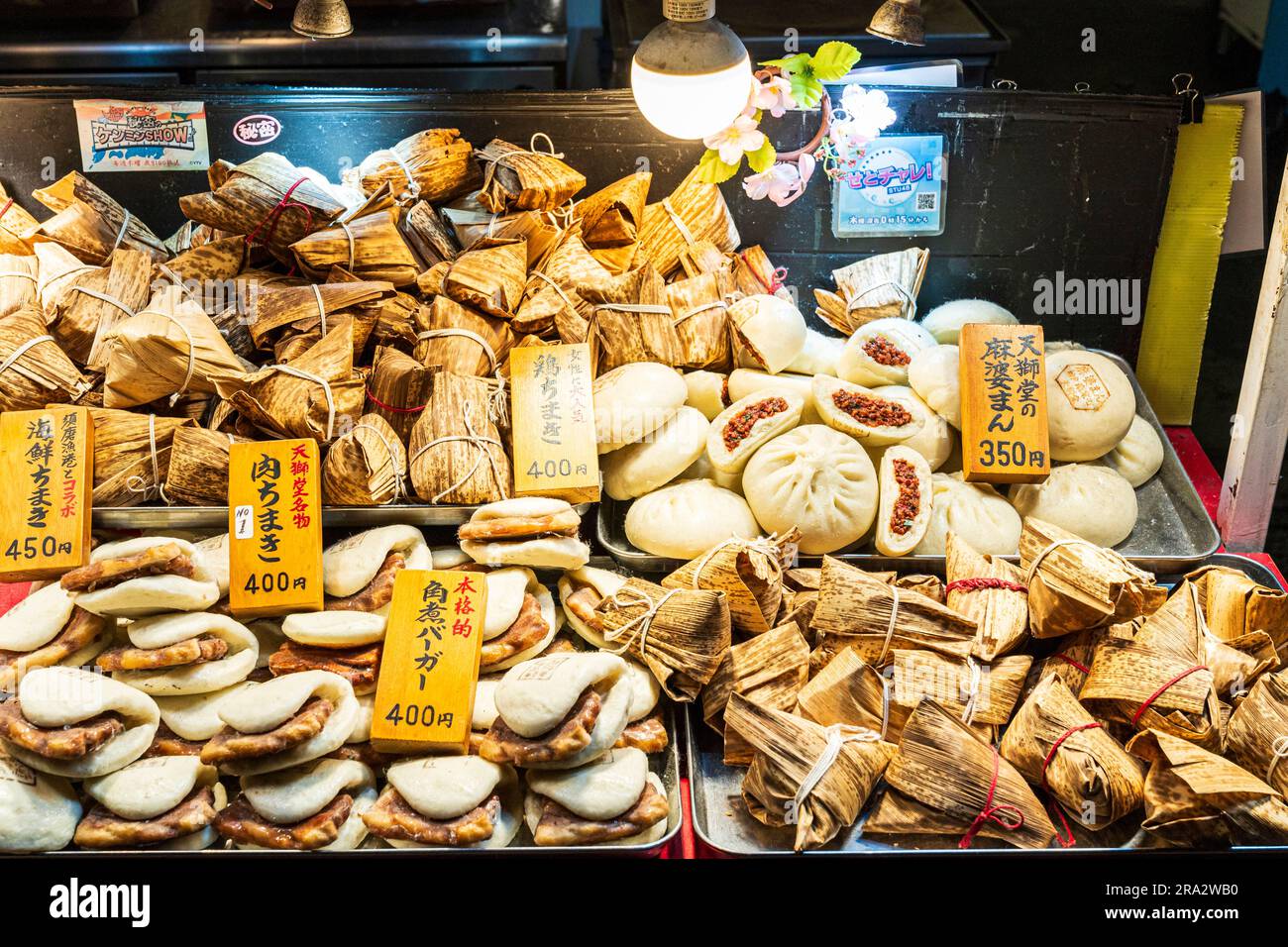 Selection of various Chinese hot food on trays on a stall in Chinatown