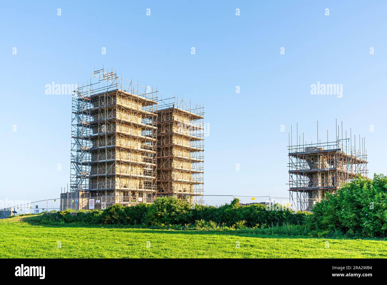 The landmark twin tower Angelo Saxon church ruins on the Kent coast at Reculver, covered over in scaffolding during conservation and restoration work. Stock Photo