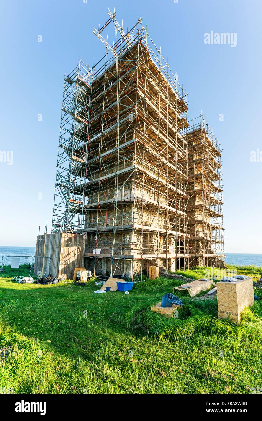 The landmark twin tower Angelo Saxon church ruins on the Kent coast at Reculver, covered over in scaffolding during conservation and restoration work. Stock Photo