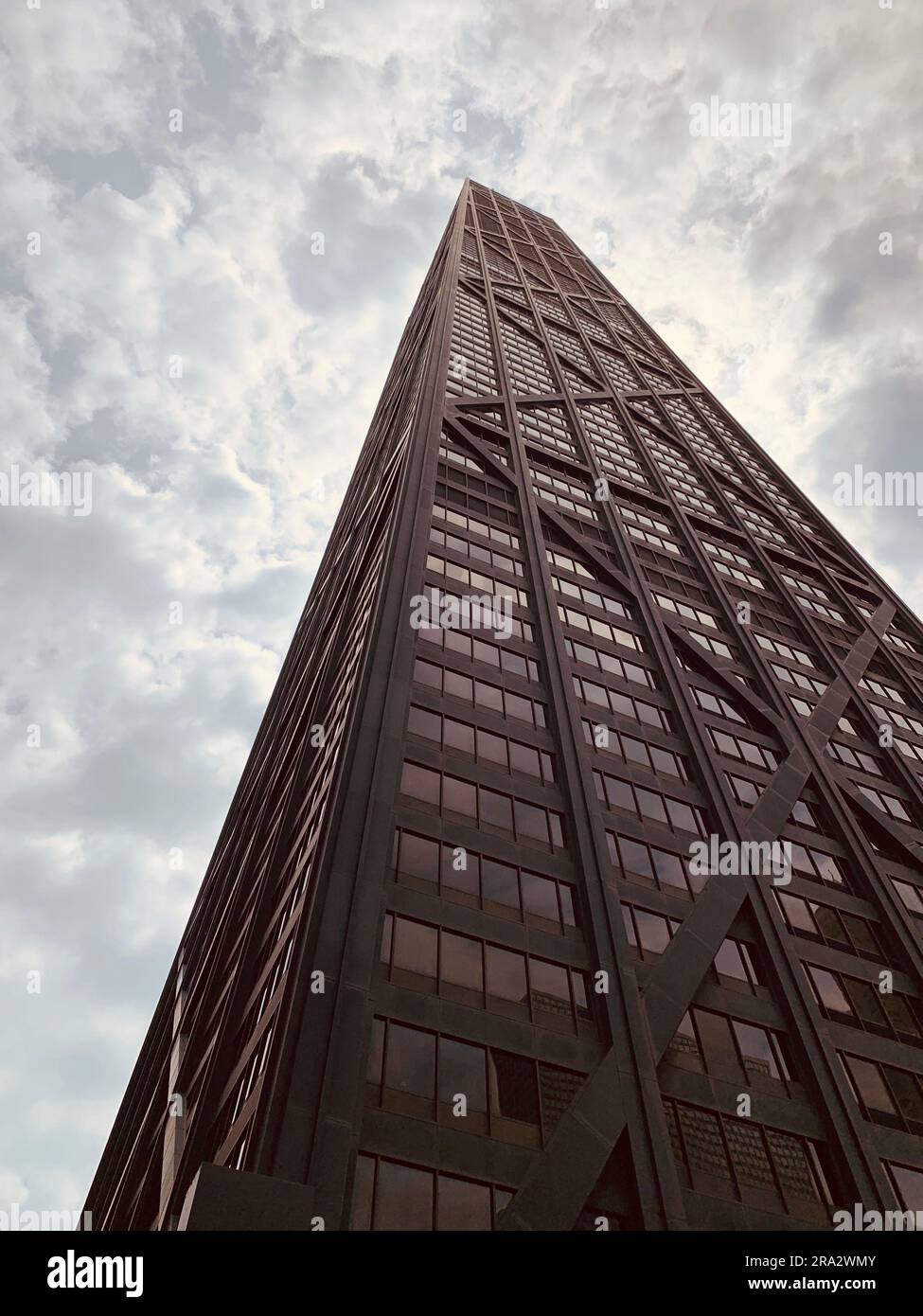 A vertical low angle shot of the Sears building under a cloudy sky in ...