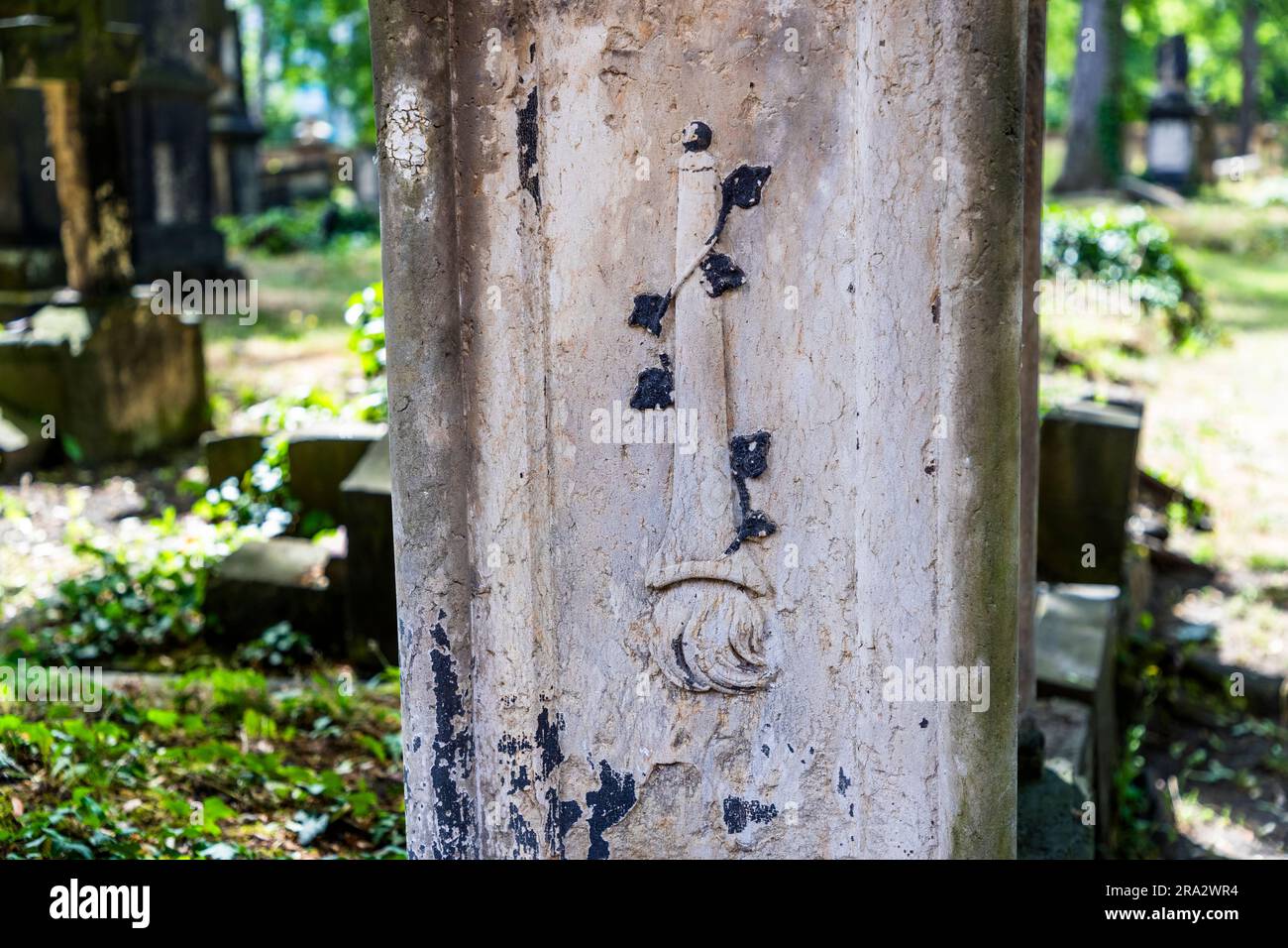 Detail of a gravestone at the Elias cemetery in Dresden with a downward pointing torch as a symbol for the extinguished life. The Elias Cemetery in Dresden, Germany, has been disused since 1876 and closed since 1924. A downward pointing torch symbolizes the end of life Stock Photo