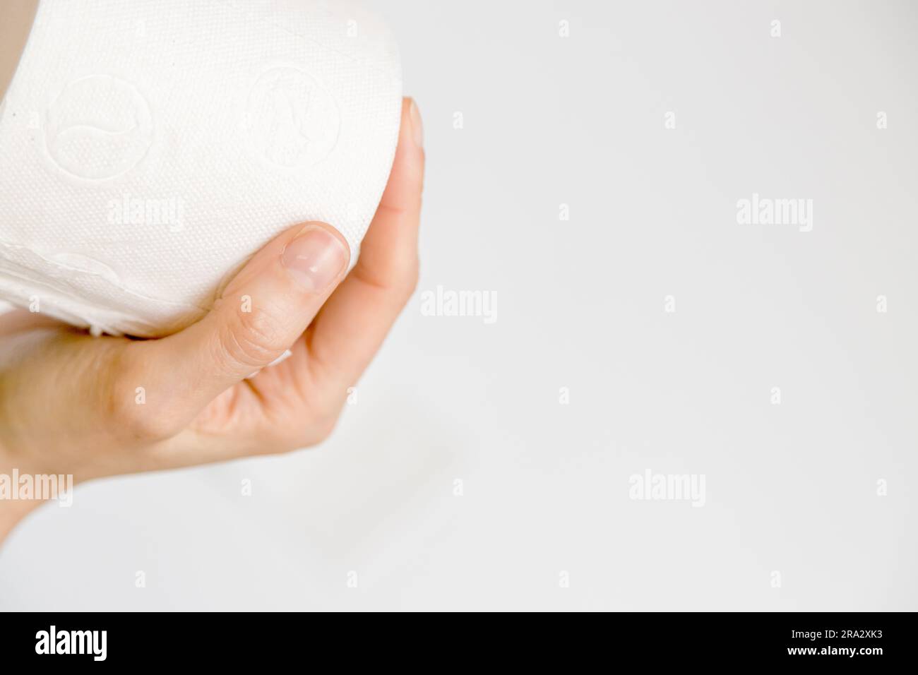 Closeup of person holding a recycled toilet paper roll in his hand over