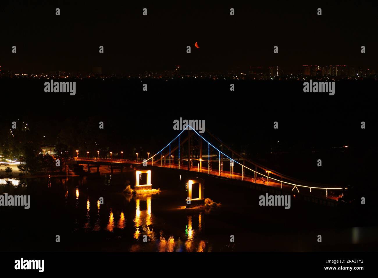 An areal shot of a bridge at night, illuminated by the street lights: Glass Bridge Kyiv, Ukraine Stock Photo