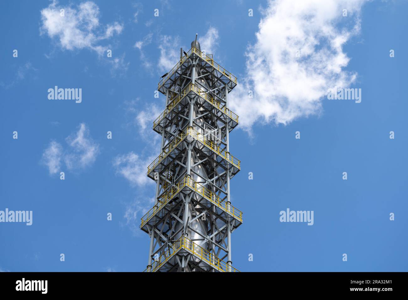 Oil refinery tower. Petroleum plant factory building. Big industrial zone equipment. Stock Photo