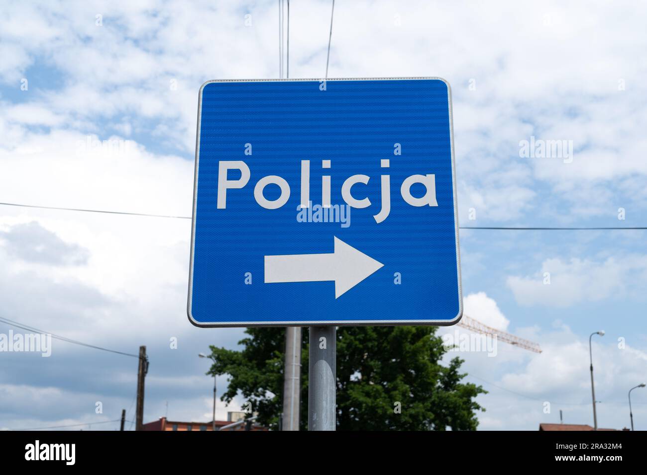 Police information road sign in Poland, indicating the location of a police station. Letters in Polish language, Policja means Police. Stock Photo