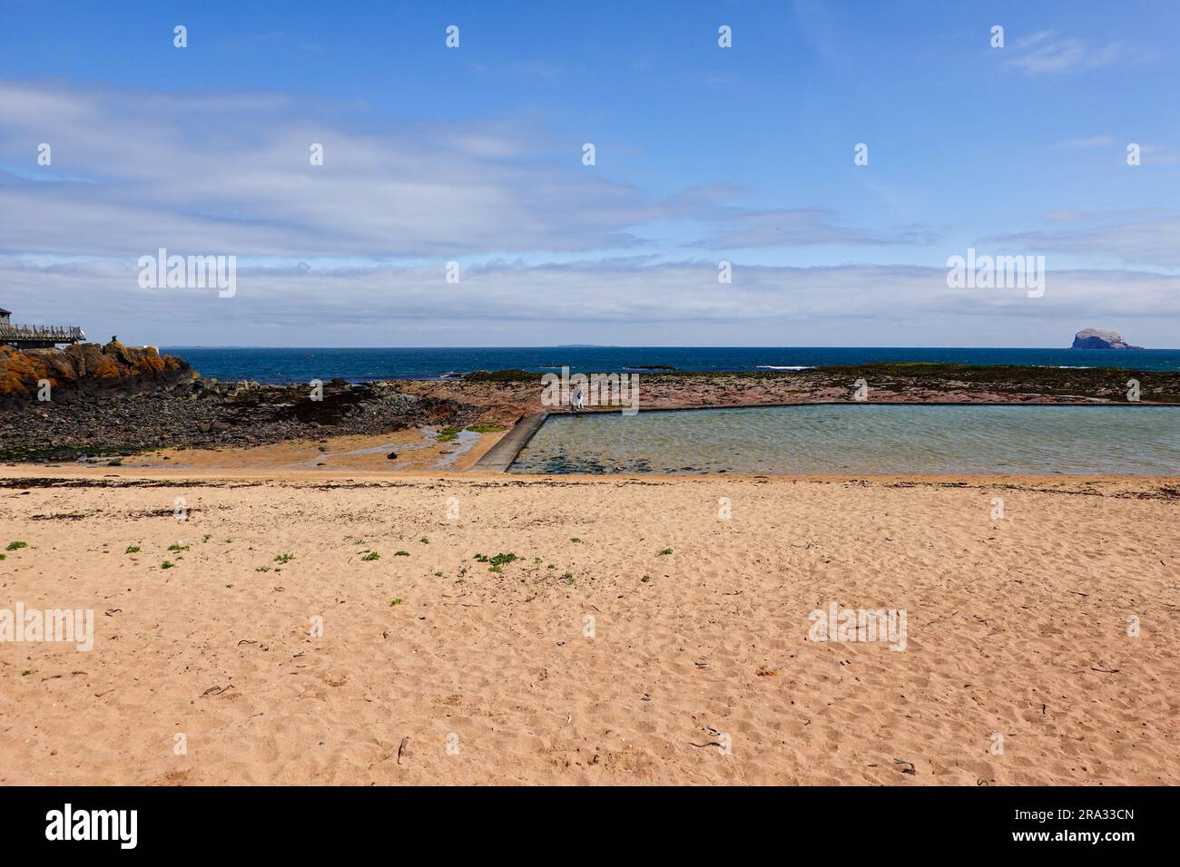 Couple walking around the edge of the tidal pool. Low tide at East