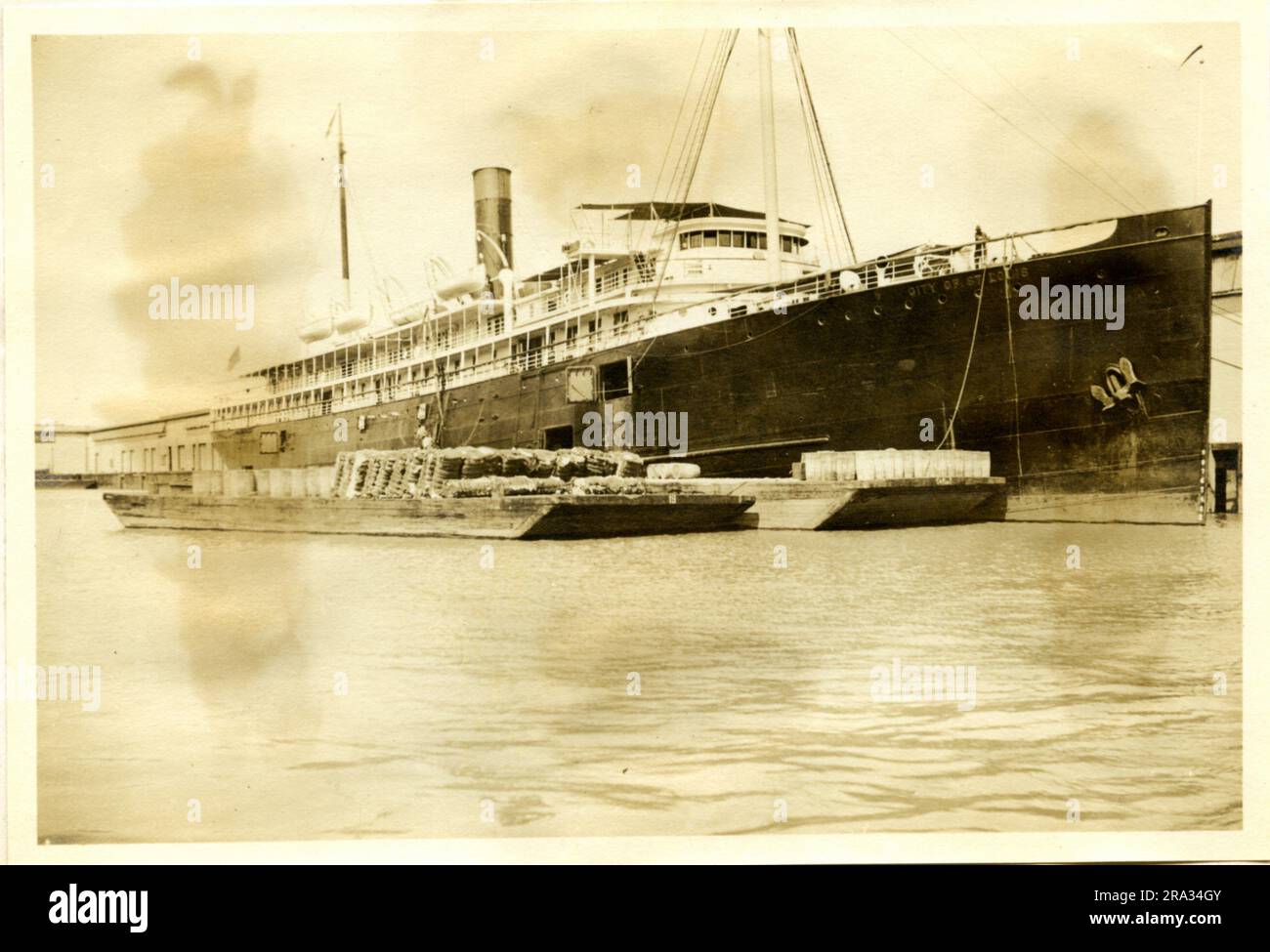 Photograph of the Starboard View of the SS City of St. Louis. Starboard View. Date: - July 19, 1918. Photograph Of: - S. S. City Of St Louis. Nationality: - American. Tonnage: - 5425. Captain: - L. Dalzell. Owners: - Ocean S. S. Co. Where From: - Boston, Mass. Destination: - Boston, Mass. Where Photographed: - Savannah, GA. Sixth Naval District. By Whom Photographed: - J. B. Dearborn. Date Photographed: - July 13th., 1918.. 1918-07-13T00:00:00. Stock Photo