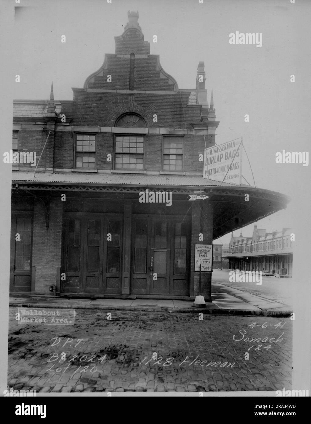 Photograph of exterior Wallabout Market, D.P. 7, Lot 120, Building 2024, 1128 Fleeman.. Architectural view of corner M. Wasserman Burlap Bags storefront, with other stores in background from negative 124.. Stock Photo
