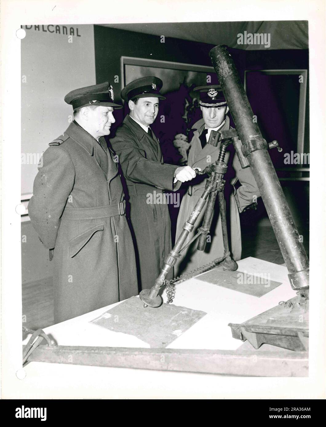 Photograph of Men in Military Uniform Inspecting Exhibit on Military ...