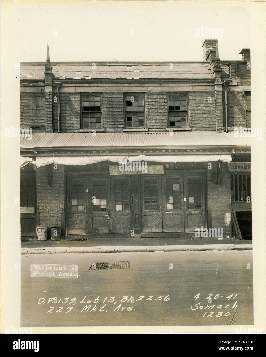 Photograph of exterior of lot 13, Bl. 2256, 229 Mkt. Ave, D.P. 139. Depicts market building exterior with sign for Mintzer & Samuels.. Stock Photo