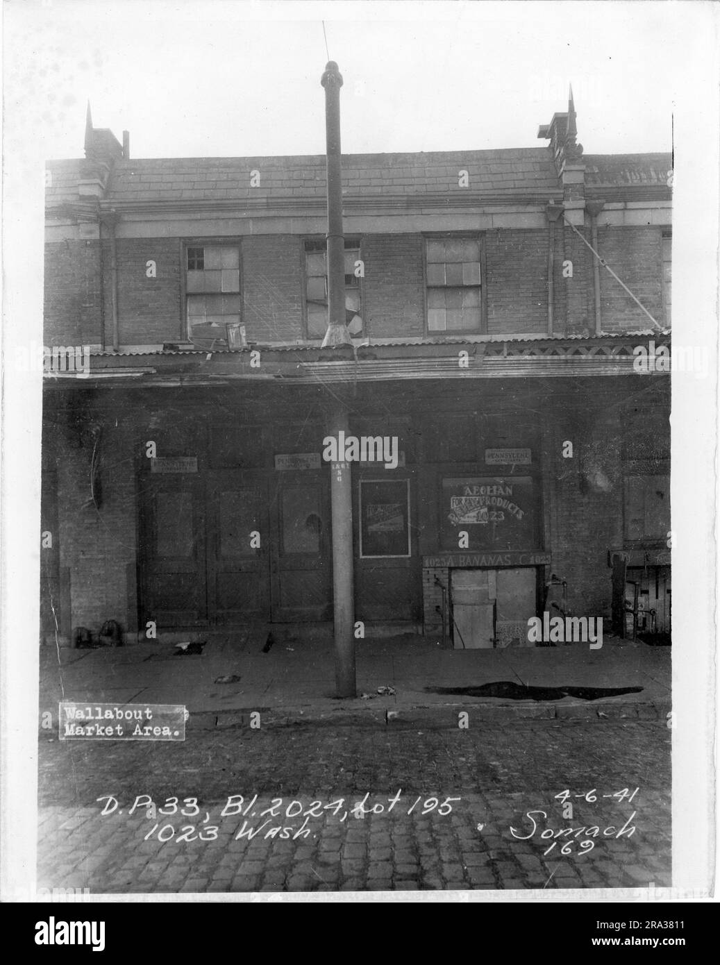 Photograph of exterior of lot 195, Bl. 2024, 1023 Wash.. Depicts exterior of building with signs for Aeolian Paper Products, and bananas. Stock Photo