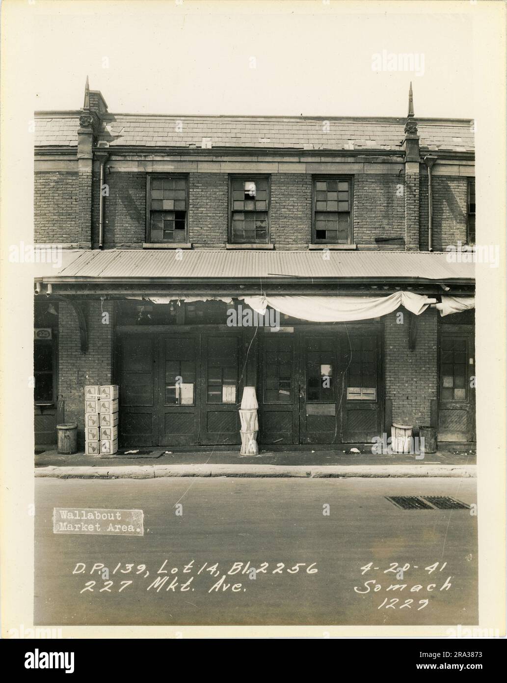 Photograph of exterior of lot 14, Bl. 2256, 227 Mkt. Ave, D.P. 139. Depicts market building exterior with sign for J. Zaimoff.. Stock Photo