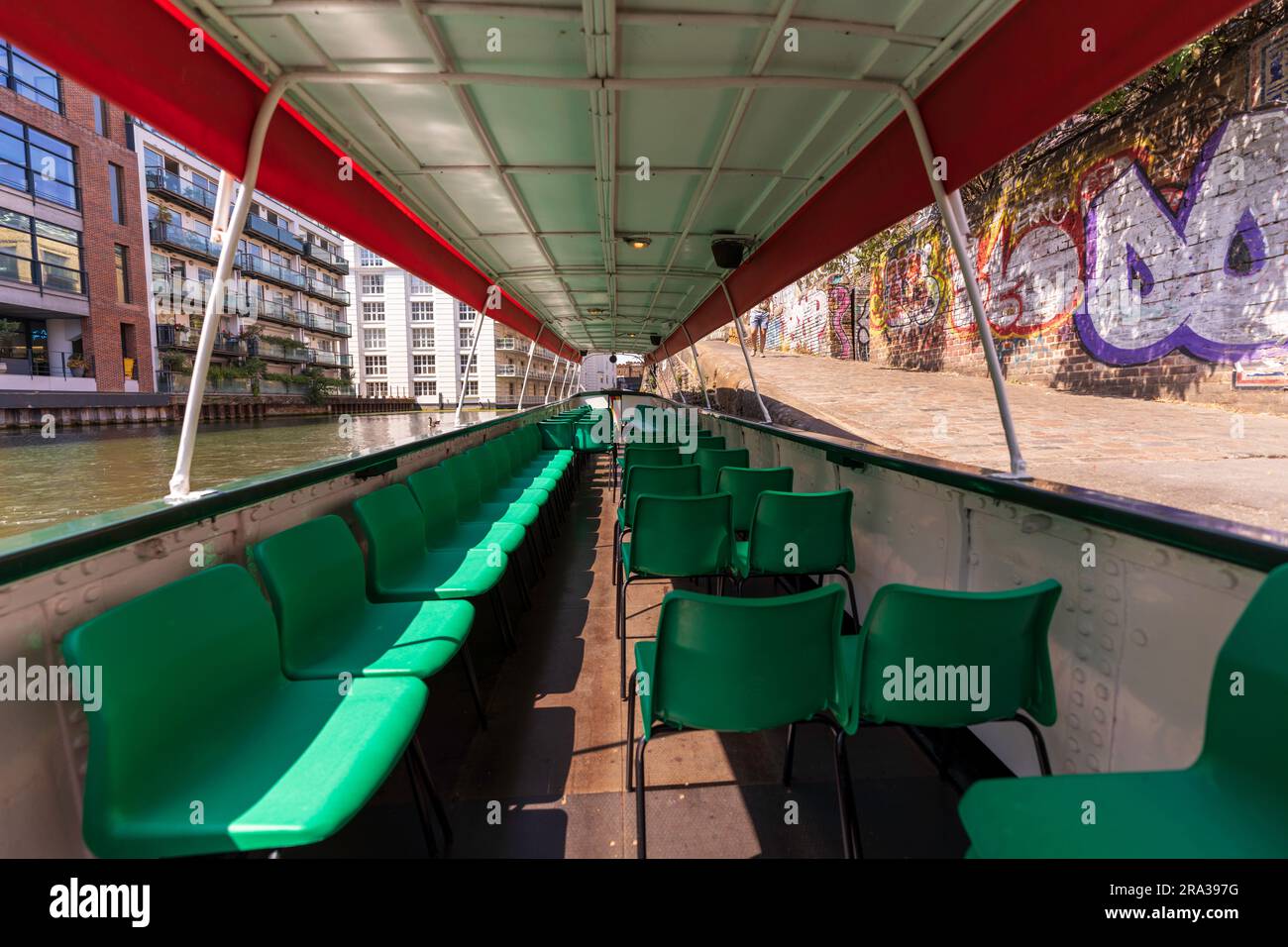 Inside a historic canal boat, a Peaky Blinders boat which is also known as a narrowboat. Take a boat tour on a London canal. Regent's Canal is perfect Stock Photo