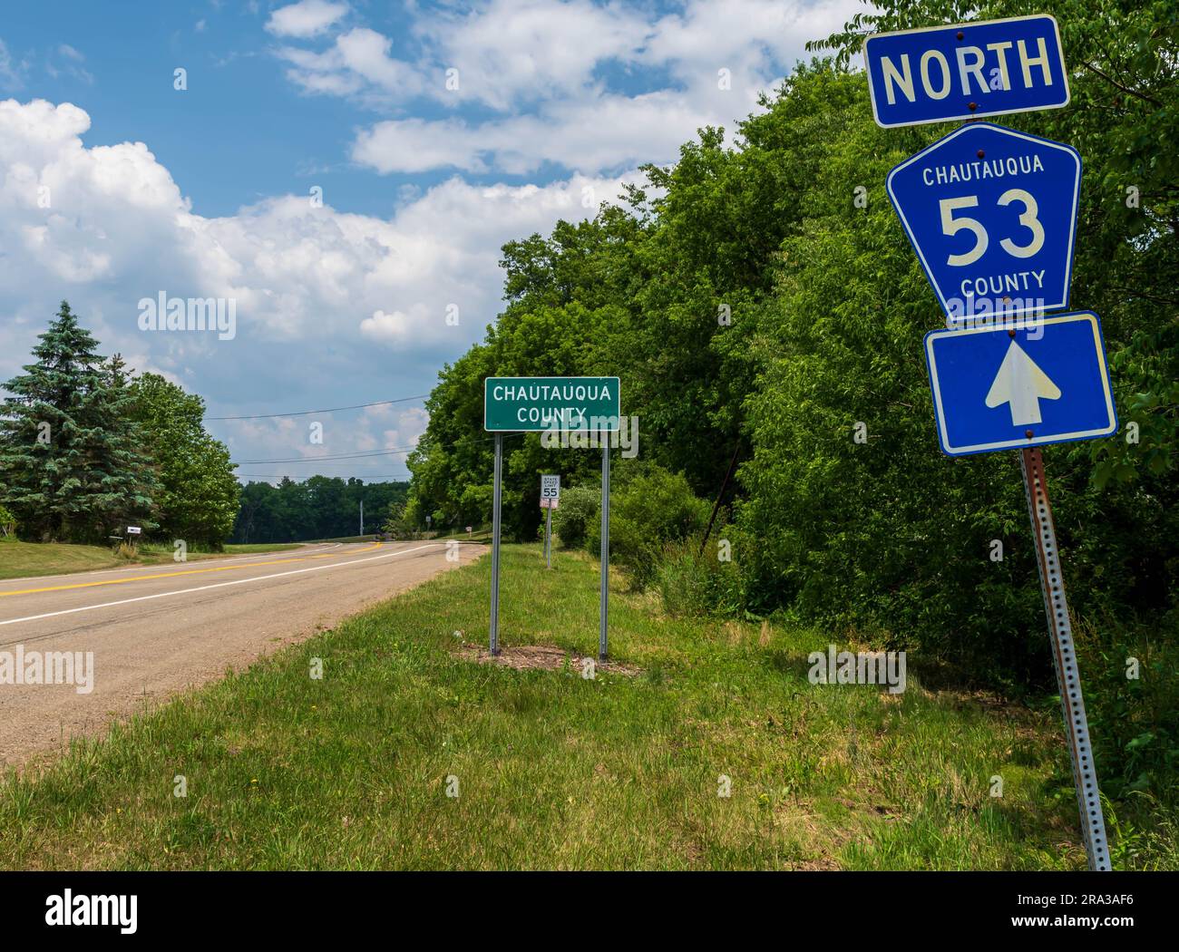 The State Route 53 North sign in front of the Chautauqua County sign in Carroll, New York, USA on a sunny summer day Stock Photo