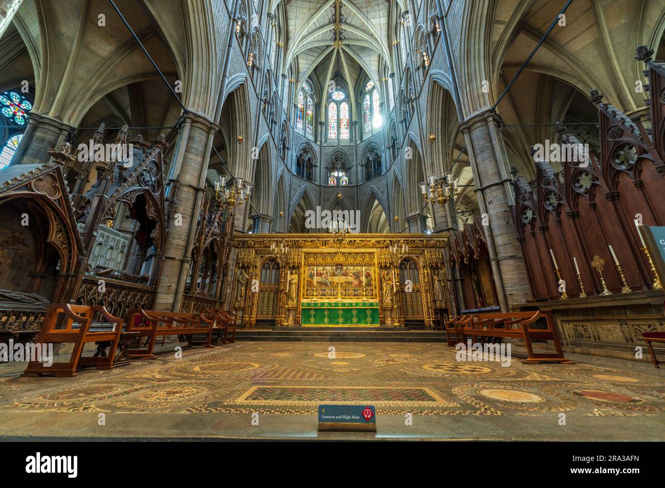 The High Altar inside the gothic Westminster Abbey. The Coronation Chair, where the monarch sits, is placed facing the High Altar during coronations. Stock Photo