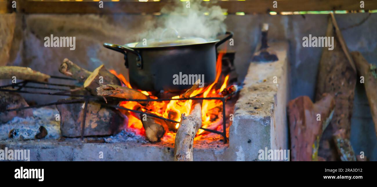 Authentic and traditional way of cooking the creole food in Seychelles, on  cast iron pot in direct wooden flames, Mahe Seychelles Stock Photo