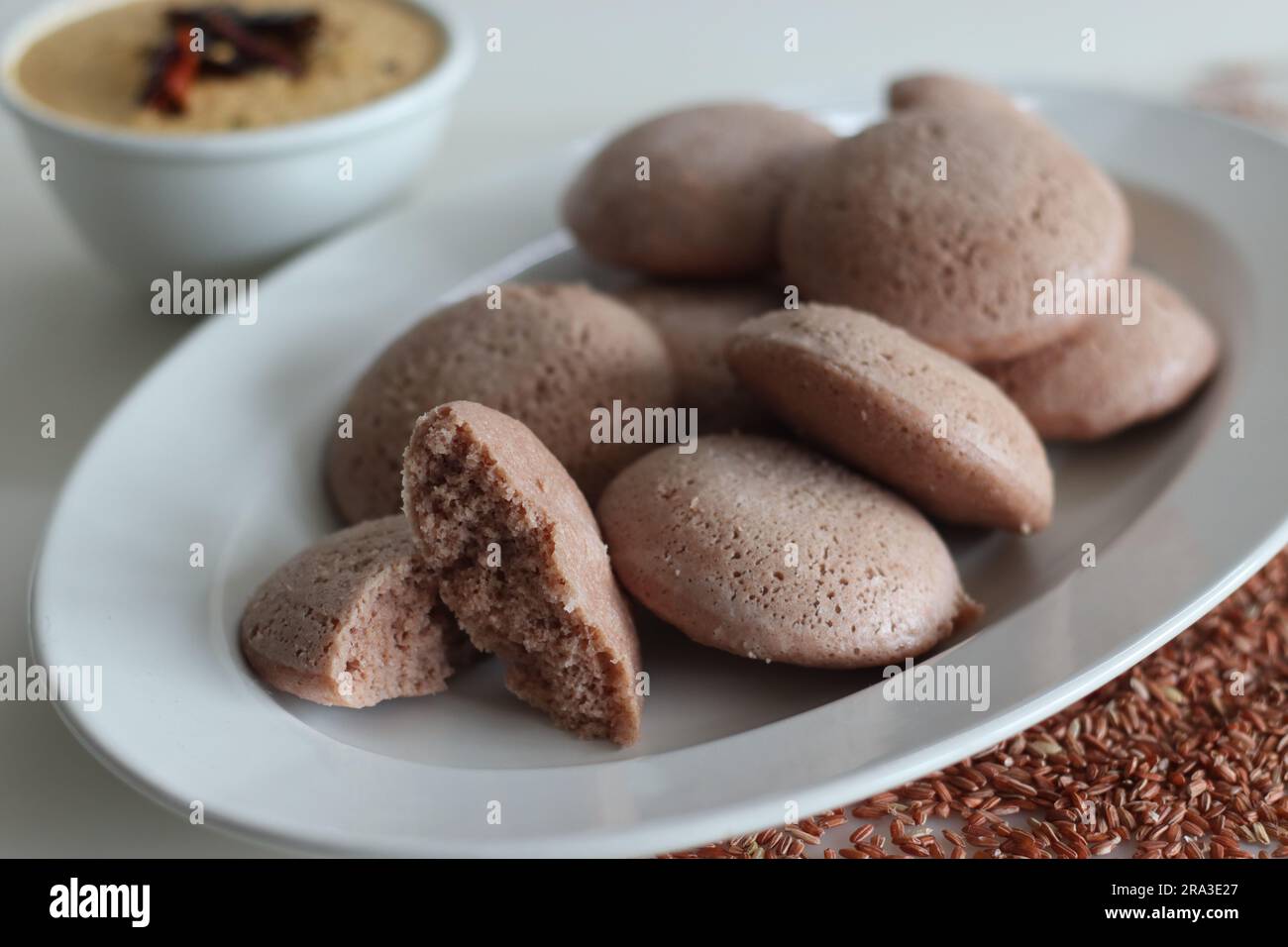 Navara rice idly. Steamed savoury rice cake made by a batter of fermented de husked black lentils and navara rice. Navara rice is an endemic rice with Stock Photo