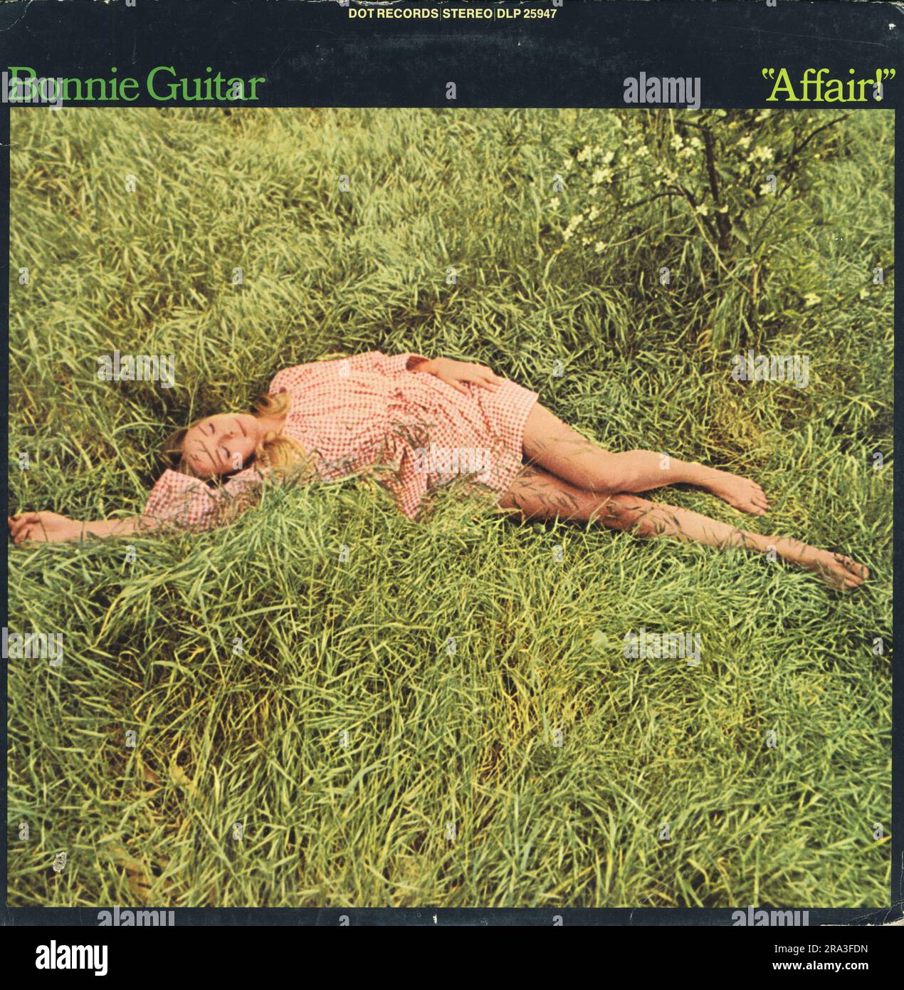 Bonnie Guitar - Affair!  LP front cover. Dot Records 1969 Art Direction – Beverly Parker (2) Design [Album Design] – Rod Dyer. Woman lying in grass in  gingham mini skirt. Sixties hippy look.  Great Sixties cover, very evocative of the hippy era in America. Stock Photo
