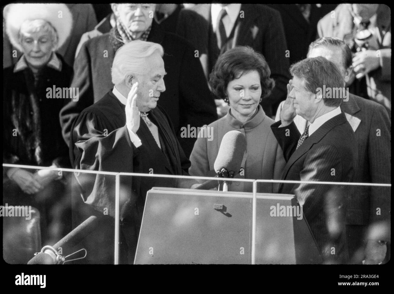 Jimmy Carter is sworn in as 39th President of the United States by Supreme Court Chief Justice Warren Burger. By Carter's side is his wife, Rosalynn and Vice President Walter Mondale. Photograph by Bernard Gotfryd Stock Photo