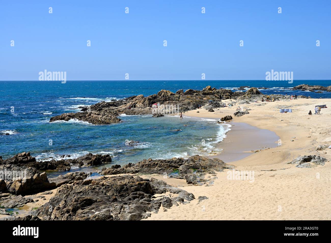 Sandy beach protected between two rocky outcrops, Leça da Palmeira, north side of Porto, Portugal Stock Photo