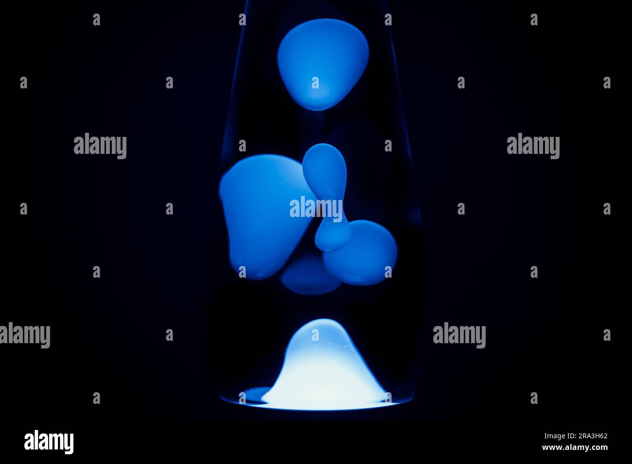 Blue lava lamp, black background, horizontal format with copy space