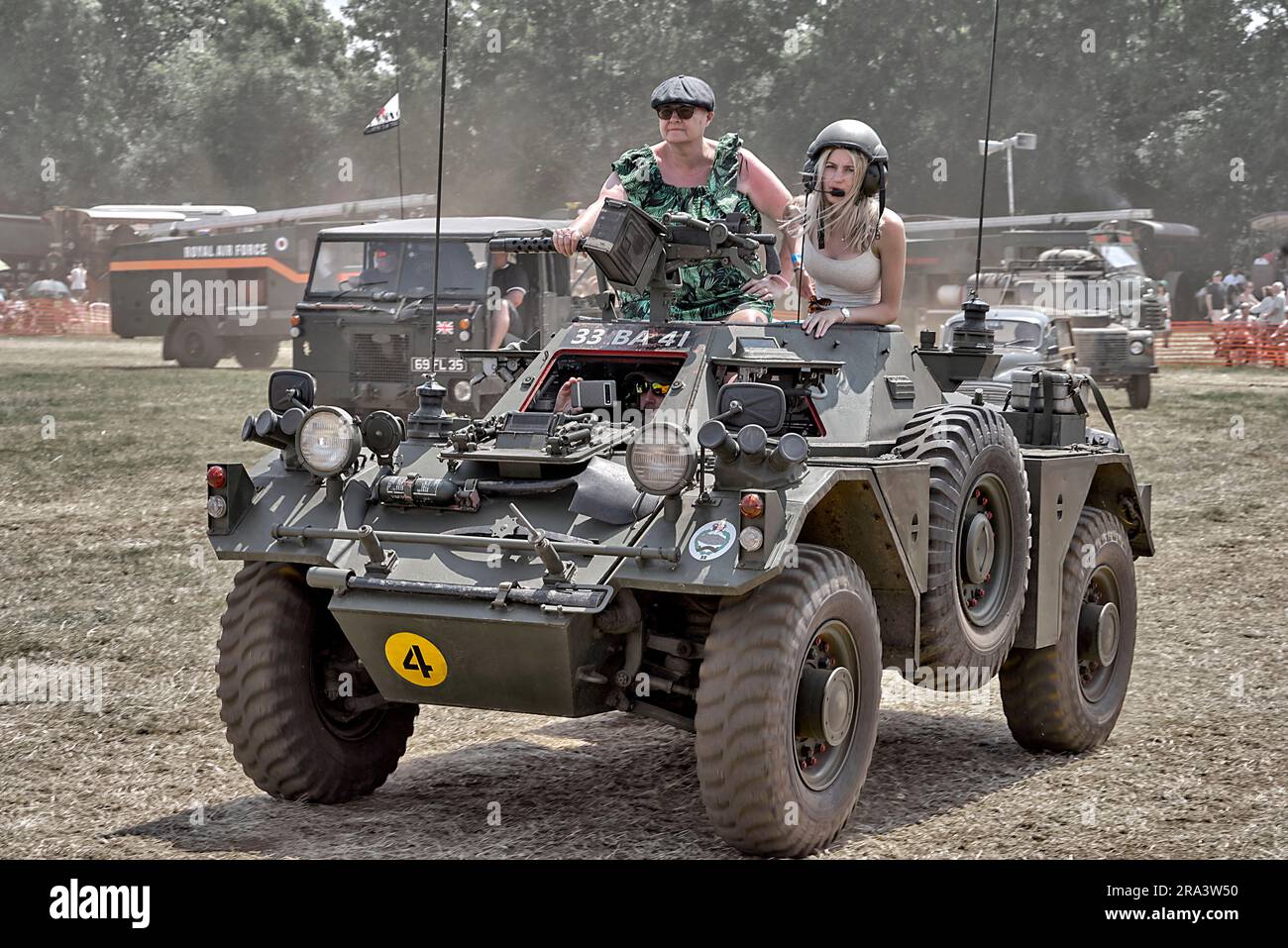 Women aboard a British army scout car 1951 Daimler Ferret F701 Mk.1/2 at a steam and vintage vehicle rally England UK Stock Photo