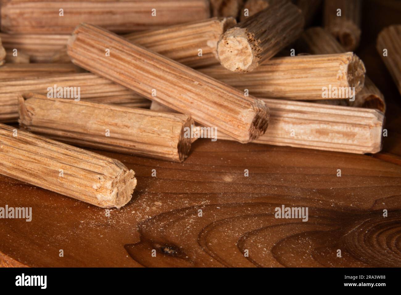 pile of oak dowel pins on cedar background, dowel pins used to join two pieces of wood, joint, joinery Stock Photo