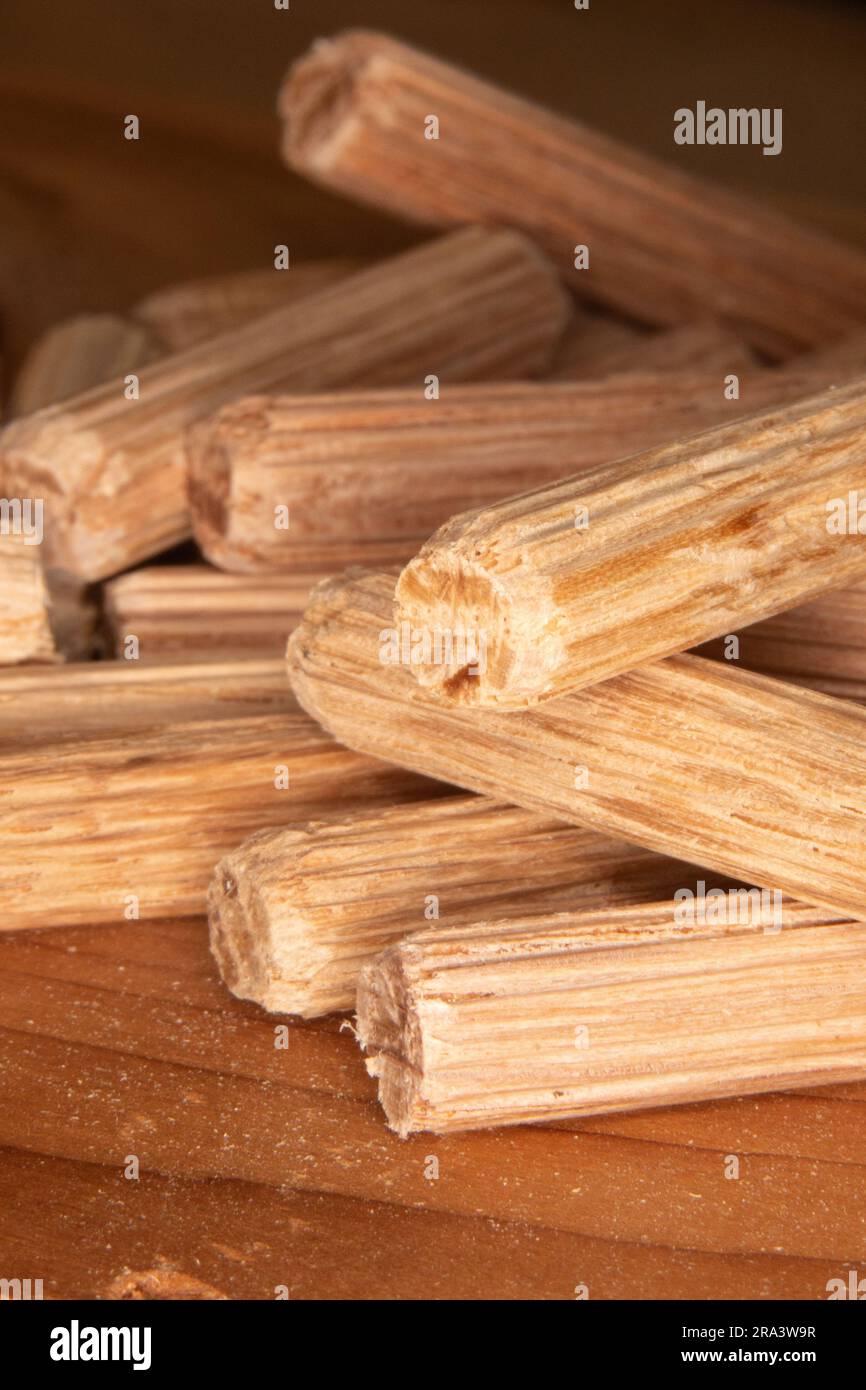 pile of oak dowel pins on cedar background, dowel pins used to join two