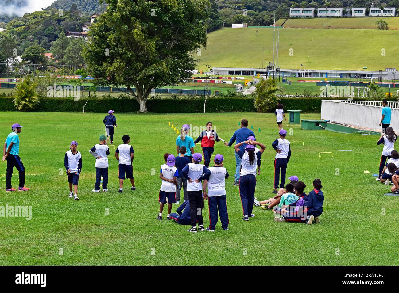 TERESOPOLIS, RIO DE JANEIRO, BRAZIL - October 25, 2022: Children doing sport activity on the grass in recreation center, 'Clube Comary' Stock Photo