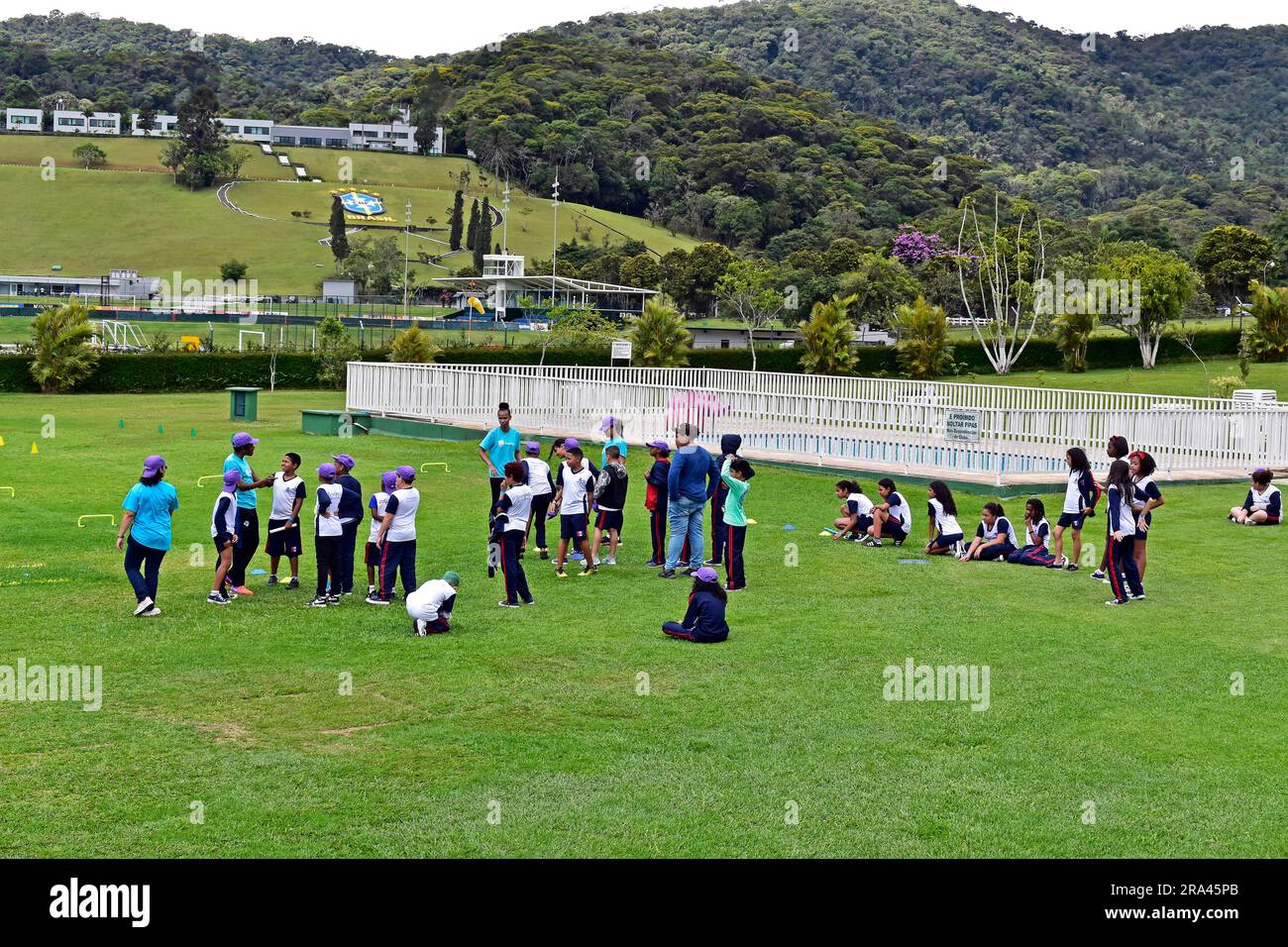 TERESOPOLIS, RIO DE JANEIRO, BRAZIL - October 25, 2022: Children doing sport activity on the grass in recreation center, 'Clube Comary' Stock Photo